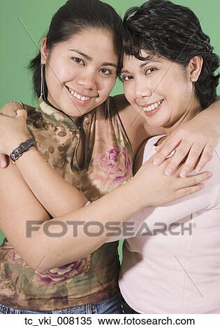 Stock Photography - Mother and daughter smiling for the camera. Fotosearch