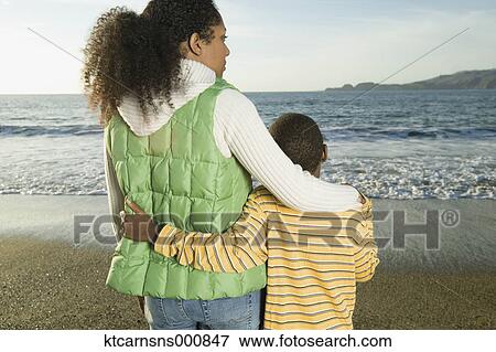 Mother and son hugging at the beach View Large Photo Image Stock Photo - Mother and son hugging at the beach. Fotosearch