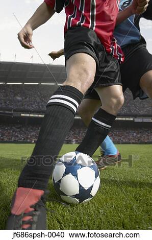 Soccer player kicking the ball View Large Photo Image Stock Image - Soccer player kicking the ball. Fotosearch