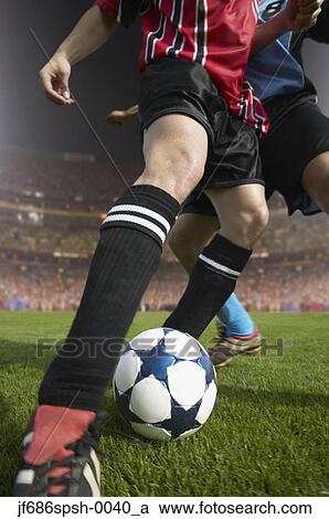 Soccer player kicking the ball View Large Photo Image Stock Image - Soccer player kicking the ball. Fotosearch