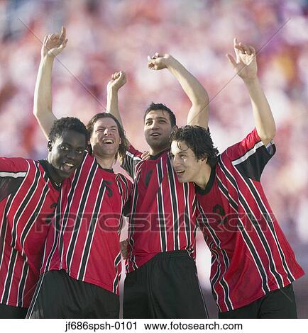 Stock Image - Soccer players celebrating victory. Fotosearch