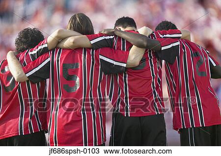 Stock Image - Soccer players hugging each other. Fotosearch