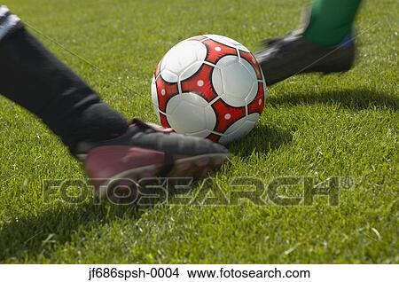 Soccer players kicking the ball simultaneously View Large Photo Image Picture - Soccer players kicking the ball simultaneously. Fotosearch