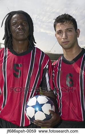 Soccer players posing for the camera View Large Photo Image Stock Photo - Soccer players posing for the camera. Fotosearch