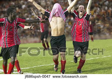 Stock Photo - Soccer team celebrating their goal. Fotosearch