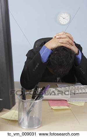 Stressed out businessman at his desk View Large Photo Image Stock Image - Stressed out businessman at his desk. Fotosearch