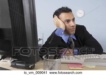 Stressed out businessman at his desk View Large Photo Image Stock Image - Stressed out businessman at his desk. Fotosearch