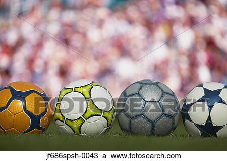 Various soccer balls lined up on grass View Large Photo Image Stock Image - Various soccer balls lined up on grass. Fotosearch