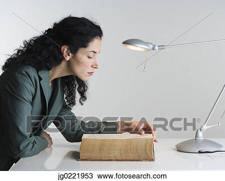 Woman reading thick book View Large Photo Image Stock Image - Woman reading thick book. Fotosearch