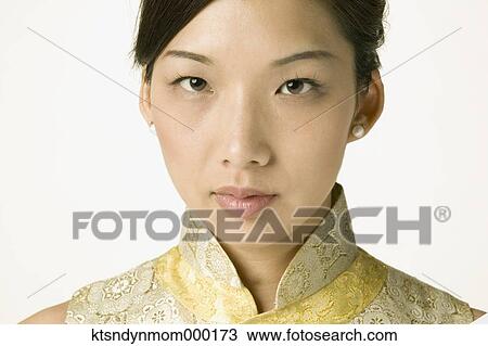 Stock Image - Young Asian woman in traditional clothes posing for the camera. Fotosearch