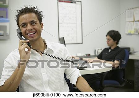 Stock Image - Young businessman talking on the phone. Fotosearch