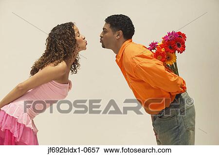 Young couple about to kiss View Large Photo Image Stock Photo - Young couple about to kiss. Fotosearch