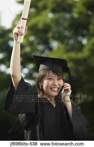 Stock Photo - Young woman graduating. Fotosearch
