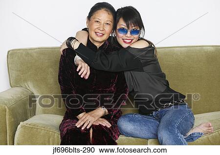 Young woman hugging her mother View Large Photo Image Stock Image - Young woman hugging her mother. Fotosearch