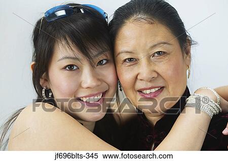 Young woman hugging her mother View Large Photo Image Stock Photography - Young woman hugging her mother. Fotosearch