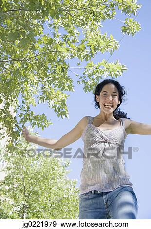 Young woman jumping for joy View Large Photo Image Stock Photo - Young woman jumping for joy. Fotosearch