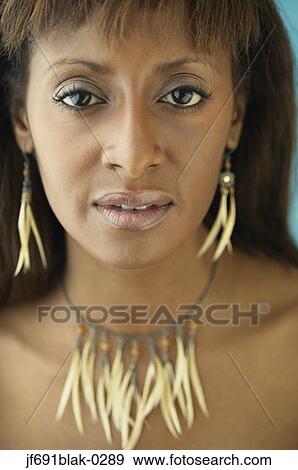 Stock Photo - Young woman posing for the camera in ethnic jewellery. Fotosearch