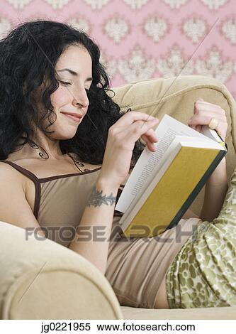 Stock Photography - Young woman reading a book. Fotosearch