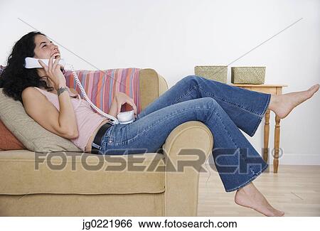 Stock Photograph - Young woman talking on the phone. Fotosearch