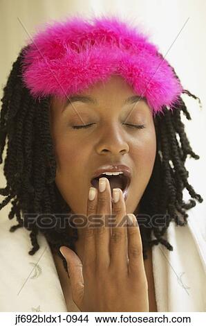 Picture - Young woman yawning. Fotosearch