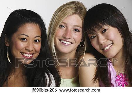 Stock Photography - Young women posing for the camera together. Fotosearch
