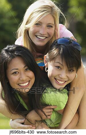 Young women smiling together View Large Photo Image Stock Image - Young women smiling together. Fotosearch