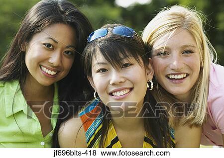 Stock Photo - Young women smiling together. Fotosearch