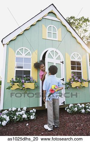 Boy holding flowers for girl View Large Photo Image Stock Image - Boy holding flowers for girl. Fotosearch