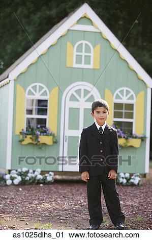 Stock Image - Boy in front of toy house. Fotosearch