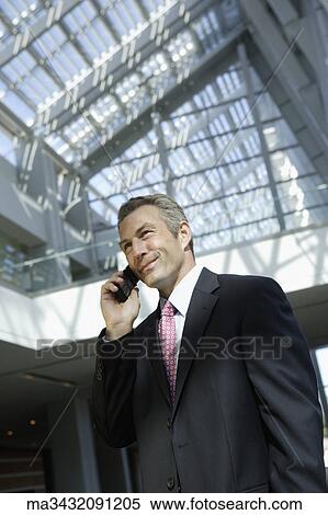 Stock Photography - Businessman talking on cell phone. Fotosearch