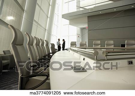 Businesspeople talking in conference room View Large Photo Image Stock Photography - Businesspeople talking in conference room. Fotosearch