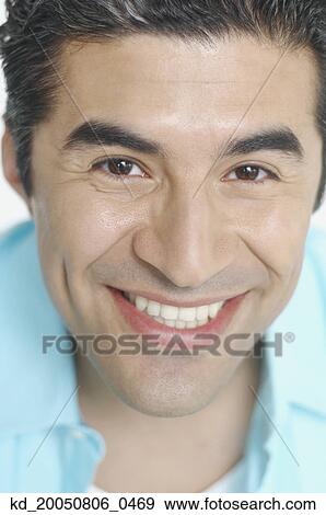 Stock Photo - Close up of young man smiling for the camera. Fotosearch