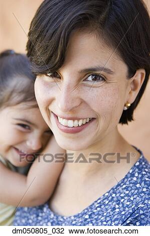 Stock Image - Close up portrait of mother and daughter. Fotosearch