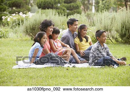 Family sitting on blanket View Large Photo Image Stock Image - Family sitting on blanket. Fotosearch