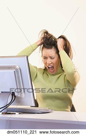 Frustrated businesswoman pulling on hair in front of computer View Large Photo Image Stock Image - Frustrated businesswoman pulling on hair in front of computer. Fotosearch