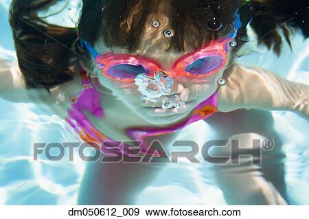 Stock Photo - Girl underwater with goggles. Fotosearch