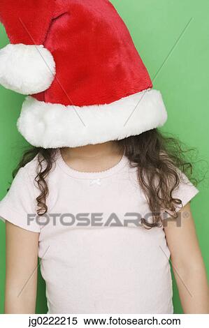 Girl with santa hat pulled down over face View Large Photo Image Stock Photography - Girl with santa hat pulled down over face. Fotosearch