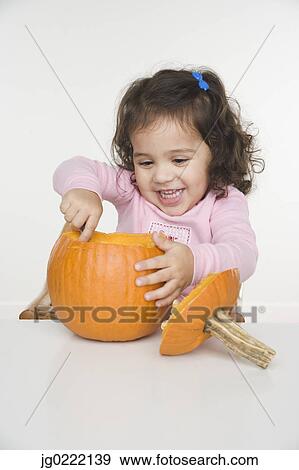 Little girl carving pumpkin View Large Photo Image Stock Photo - Little girl carving pumpkin. Fotosearch