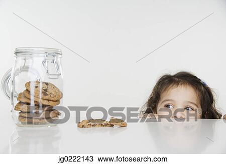 Little girl looking at cookie jar View Large Photo Image Stock Image - Little girl looking at cookie jar. Fotosearch
