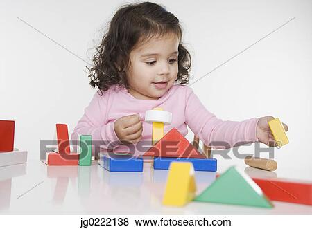 Stock Photo - Little girl playing with blocks. Fotosearch