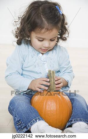 Little girl with pumpkin View Large Photo Image Stock Image - Little girl with pumpkin. Fotosearch