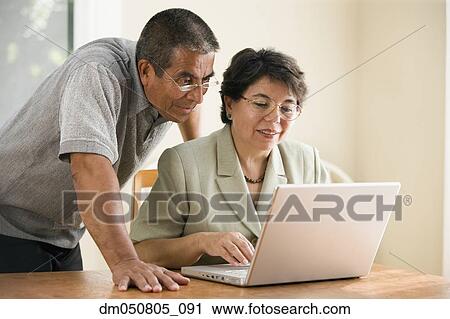 Mature couple working on laptop View Large Photo Image Stock Image - Mature couple working on laptop. Fotosearch
