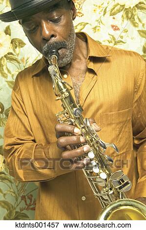 Middle aged man playing the saxophone View Large Photo Image Stock Photo - Middle aged man playing the saxophone. Fotosearch
