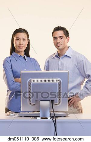 Stock Photograph - Portrait of businesspeople at computer. Fotosearch