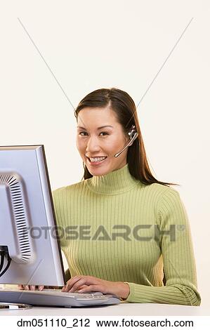 Stock Image - Portrait of businesswoman at computer. Fotosearch