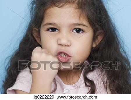 Stock Image - Portrait of girl making fist. Fotosearch