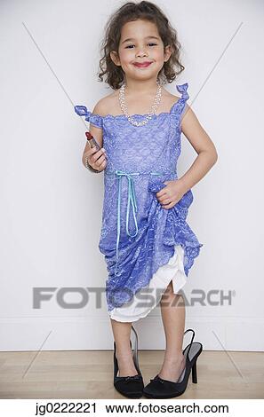 Stock Image - Portrait of girl playing dress up. Fotosearch