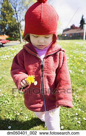 Stock Image - Portrait of girl with dandelion. Fotosearch