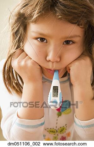 Stock Image - Portrait of girl with thermometer in mouth. Fotosearch