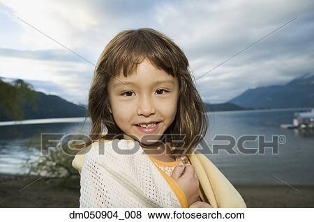 Stock Photo - Portrait of girl wrapped in towel at lake. Fotosearch